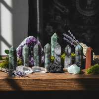 Collection of crystals and decorative items on a wooden surface with a dark background